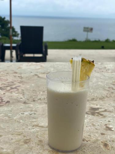 a glass of milk with a piece of food in it at Vista Mare Samana The Best View!! in Santa Bárbara de Samaná