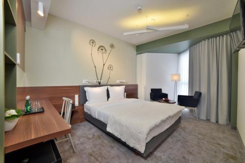 a hotel room with a bed and a desk at Focus Hotel Premium Lublin Conference & SPA in Lublin