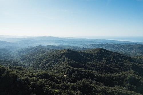 an aerial view of a lush green mountain range at Pueblo del Sol Hotel Retreat in Puerto Escondido