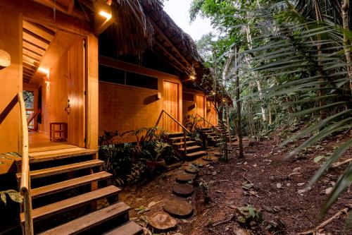 a porch of a house with stairs and plants at Pueblo del Sol Hotel Retreat in Puerto Escondido