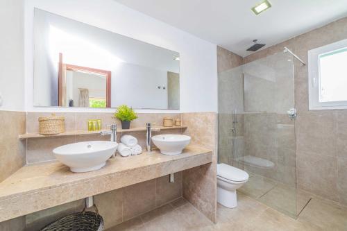 a bathroom with a sink and a toilet and a shower at Villa Ambient / Sa Finqueta in Muro