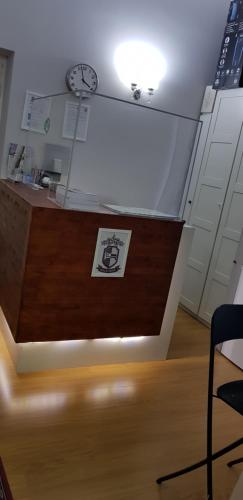 a desk with a clock on top of a room at Duca di Cavour in Rome