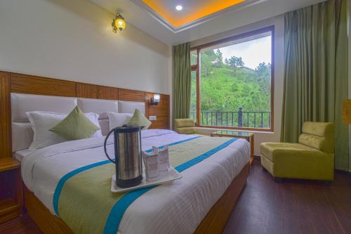 a hotel room with a bed and a window at Hotel The Paal in Shimla