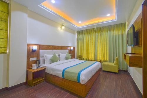 a hotel room with a bed and a chair at Hotel The Paal in Shimla