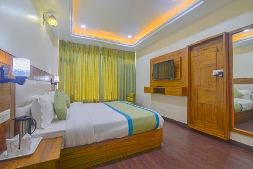 a hotel room with a bed and a television at Hotel The Paal in Shimla