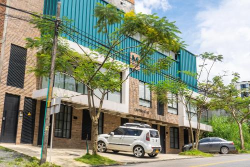 a white suv parked in front of a building at M1145 Aparta Loft in Pereira