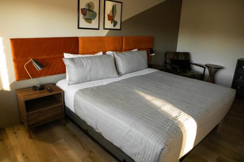 a bedroom with a large bed with a wooden headboard at 4411 Inn & Suites in Michigan City