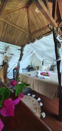 a bedroom with a bed in a tent at Hotel ECOLODGE LE RAVORAHA in Sainte Marie