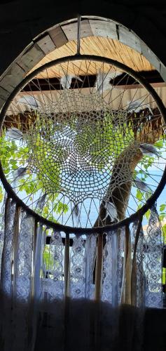 a glass window with a reflection of a giraffe at Hotel ECOLODGE LE RAVORAHA in Sainte Marie