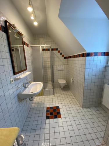 a bathroom with a sink and a toilet at Landcafe Auszeit in Albersdorf