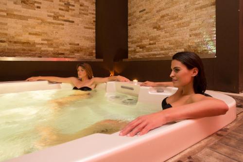 two women sitting in a bath tub at Marina Holiday & Spa in Balestrate