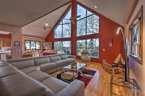 a living room with a couch and large windows at Lake Cumberland Home with Deck and Water Access! in Monticello