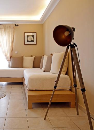 a room with a bed and a tripod astronomer at Oasis Beach Hotel in Skala