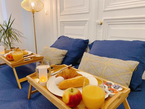 a table with a tray of bread and apples on it at CoCo Romantic - apartment in most trendy central hotspot of Antwerp in Antwerp