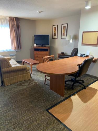 a living room with a table and a couch at Candlewood Williamsport, an IHG Hotel in Williamsport