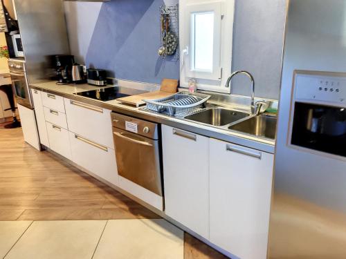 a kitchen with a sink and a counter top at Résidence Verdi - Appartements meublés en centre ville in Bédarieux