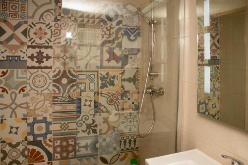 a bathroom with a shower and a sink and a mirror at B&S Accommodation Renovated 18 Century House of Character in Ghaxaq in Hal Ghaxiak