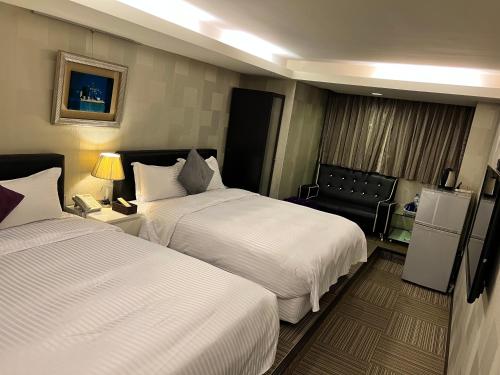 En eller flere senge i et værelse på 意芙旅店 Ifinn Hotel