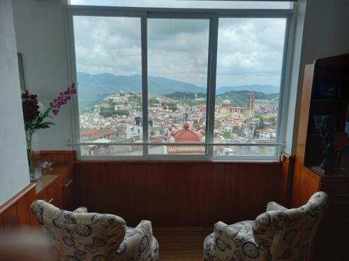 a large window with a view of a city at Casa Vista hermosa de taxco in Taxco de Alarcón