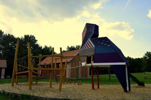 a playground with a slide in front of a building at Őrálló Szer in Őriszentpéter