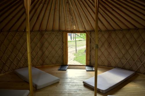 an interior of a yurt with two beds in it at Őrálló Szer in Őriszentpéter