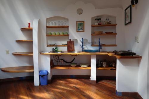 a kitchen with a table and shelves in a room at Hotel La Cupula in Copacabana
