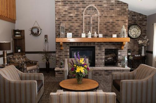a living room filled with furniture and a fire place at AmericInn by Wyndham Aberdeen Event Center in Aberdeen