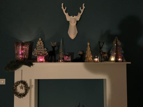 a fireplace with christmas decorations on top of it at Villa Le Brame in Ciney
