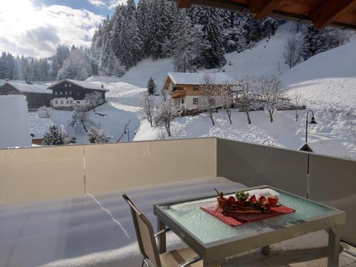 a table with a bowl of fruit on top of a balcony at Appartement Fritzenwallner in Wagrain