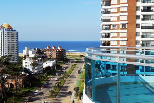a view of the ocean from the balcony of a building at Sol y Luna 2 Punta del Este - Apartamentos Full Amenities in Punta del Este