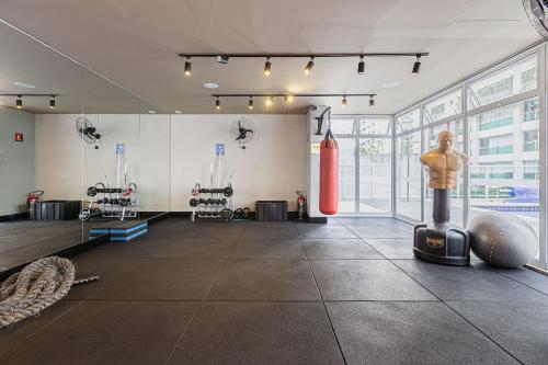 a gym with a man in the middle of the room at Vossa Bossa Vision in Sao Paulo