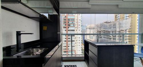 a bathroom with a sink and a large window at Vossa Bossa Vision in Sao Paulo