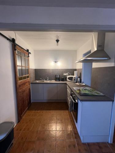a kitchen with a stove and a counter top at Le cocon des Nestes in Arreau