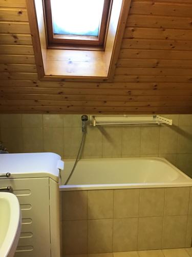 a bathroom with a bath tub and a sink at WIEDWEG GOLD in Wiedweg