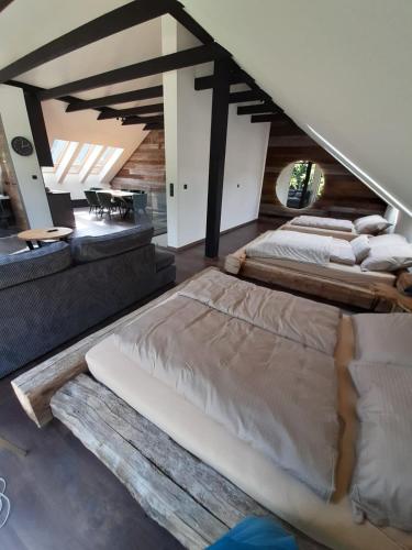 a bedroom with two beds and a dining room at Dom Minimal House in Szczyrk