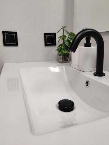 a kitchen sink with a black faucet at New Apartment Claret in Xàtiva