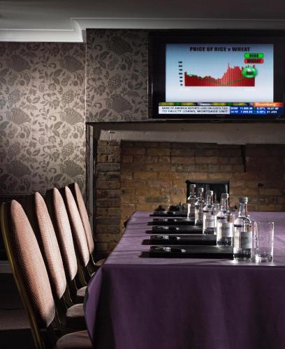 a table in a room with a table cloth at The Boleyn Hotel in Staines