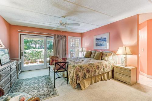 a bedroom with a bed with orange walls and a window at Sailmaker in Fernandina Beach