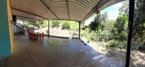 a view of a patio with a table and chairs at EcoHostal Tierra Prometida in Santa Marta