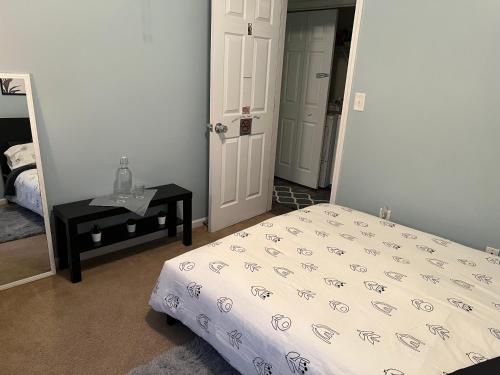 a bedroom with a bed and a table and a mirror at BlaBla Lounge in Charlotte
