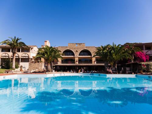 a large swimming pool in front of a resort at Hotel Costa dei Fiori in Santa Margherita di Pula