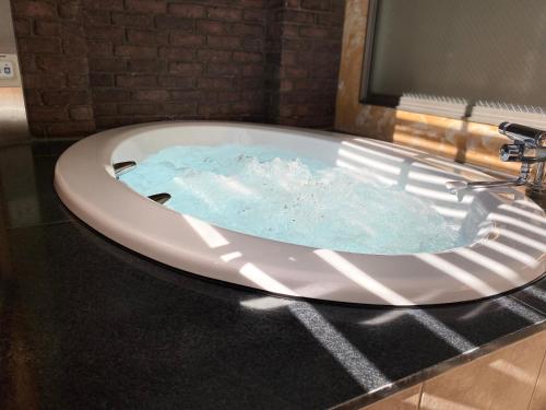 a bath tub with blue water in a bathroom at Gifu Movie Movie (Adult Only) in Gifu