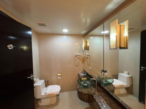 a bathroom with a sink and a toilet at Raintree Resort Suites in Petaling Jaya