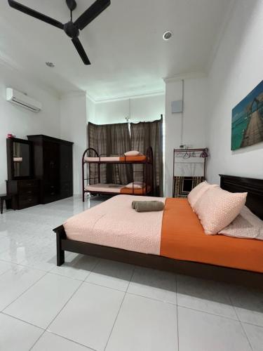 a bedroom with two bunk beds in a room at AmVilla in Kota Bharu