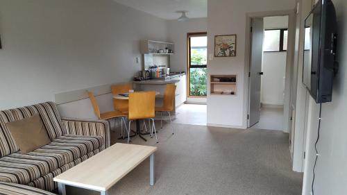 a living room with a couch and a table at Akaroa Waterfront Motels in Akaroa