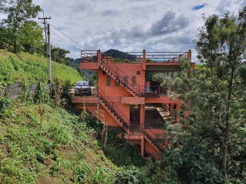 an orange building on the side of a hill at Terre Terrace Glamping - Doichang in Ban Huai Khai