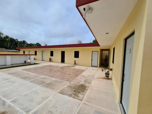 an empty parking lot in front of a building at Hotel La Piramide Izamal in Izamal