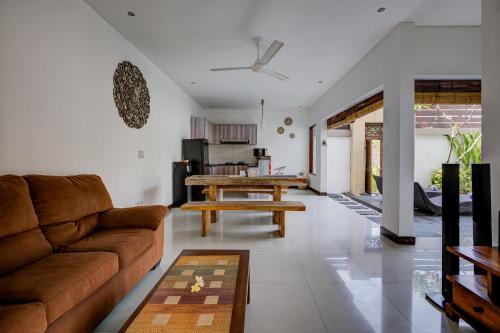 a living room with a couch and a table at Villa Raka Managed by Manara in Legian