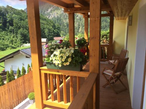 a balcony with a pot of flowers on it at Landhaus Constantin Luxus-Appartments in Berchtesgaden