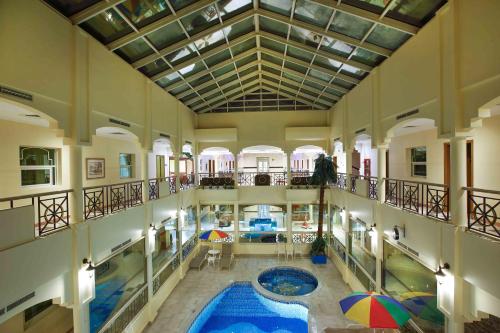 an indoor pool in a building with an indoor swimming pool at Al Seef Hotel in Sharjah